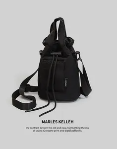 Detail of black nylon drawstring bucket bag with mesh pocket and adjustable strap