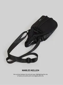 Detail of black sports bucket bag featuring adjustable strap and AOTUAT woven label