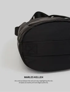 Close-up of black nylon bucket bag with cross-stitched bottom and sturdy strap detail