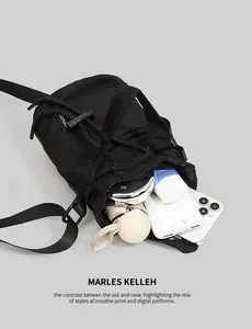 Internal storage detail of black nylon bucket bag with phone and daily essentials