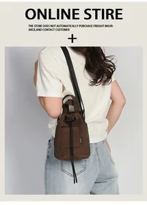 Detail of coffee canvas bucket bag with adjustable black strap and drawstring closure