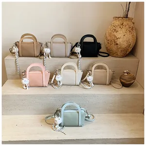 Borsa a secchiello da donna con trama litchi, ciondolo a gatto e tracolla rimovibile