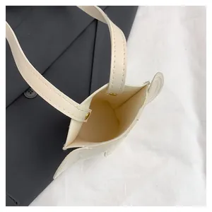 Minimalist cream white elephant mini crossbody bag with unique 3D wing-shaped side details