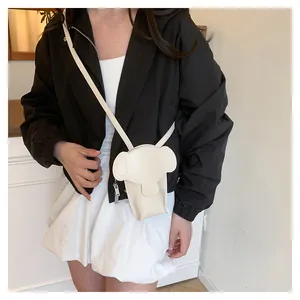 Close-up of elephant-shaped crossbody bag showing cream white faux leather and fine stitching