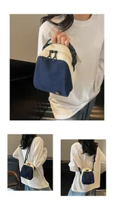 Detail of compact shell bag with dual-tone canvas denim and sturdy zip pullers