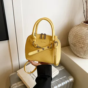 Bright yellow shell crossbody bag with litchi texture and adjustable shoulder strap