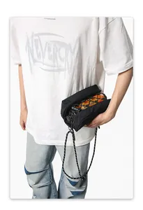 Detail of crossbody bag featuring an orange transparent cylinder and woven rope strap
