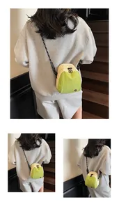 Detail of mini shell crossbody bag with green-beige panels and woven rope strap
