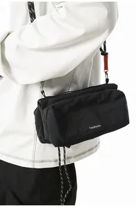Detail of black techwear crossbody bag with woven rope strap and Taoleyou branding