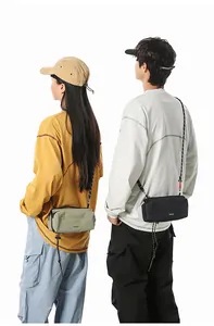Detail of lightweight crossbody bag with adjustable rope strap and minimalist branding