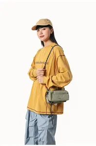 Detail view of lightweight nylon crossbody bag in olive green with functional strap