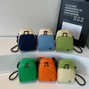 Lightweight shell-shaped crossbody bags in six vibrant colors with woven shoulder straps