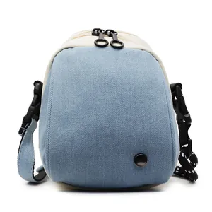 Light blue denim texture shell bag with adjustable black strap and dual zipper closure