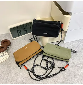 Nylon crossbody bags in black, tan and green colors with braided rope straps