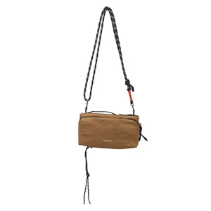 Brown nylon crossbody hiking bag with decorative woven rope strap and zipper closure