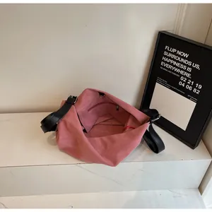 Minimalist dusty rose canvas tote bag with black leather strap and spacious interior