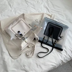 Stylish large capacity clear PVC tote bag with leather pocket and bear charm in black and white