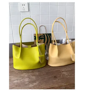 Close-up of lime green and beige tote bags with pebble grain texture and accessories