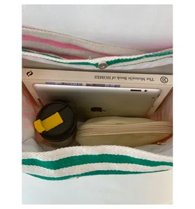 Top view of spacious canvas tote interior holding a tablet, books, and accessories