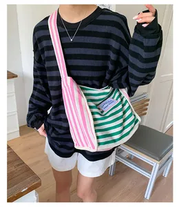 Close-up of canvas shoulder bag with colorful stripes and Cherish Keep Good patch