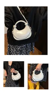 Detail of white crescent bag with spherical accents and detachable metal chain strap