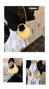 Detail view of mini cream yellow crossbody bag with silver chain and leather handle