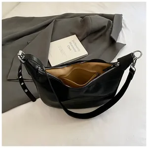 Minimalist black crocodile pattern underarm bag with adjustable silver eyelet strap
