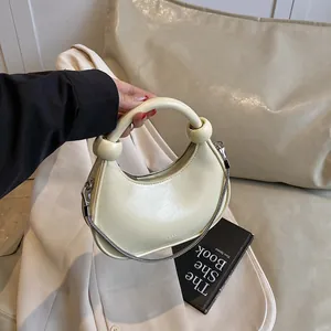 Chic cream white hobo bag with knotted handle and elegant silver chain strap for summer