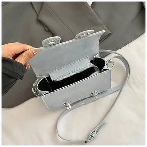 Light blue faux leather crossbody bag with crocodile texture and silver locks