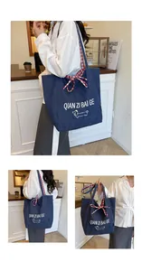 Detail of blue denim tote bag with red gingham lining and cute dachshund print