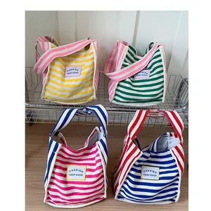 Striped canvas shoulder bags with CHERISH labels in four colorful contrast variations