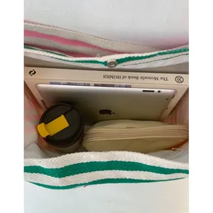 Top view of large striped canvas tote bag showing spacious interior with tablet and books