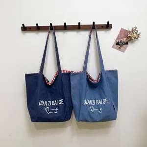 Striped denim tote bag with dachshund print and red checkered lining in blue shades