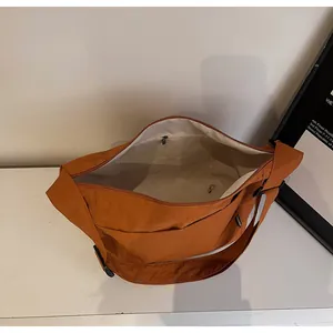 Interior view of caramel canvas tote bag showing large capacity and zipper pocket