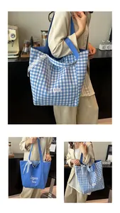 Detail of canvas tote bag with lace bow decoration and blue gingham pattern in cafe setting