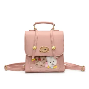 Sac à dos rose minimaliste en similicuir avec fenêtre et décorations en peluche