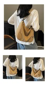 Detail of khaki crescent tote bag showing durable canvas texture and wide shoulder strap