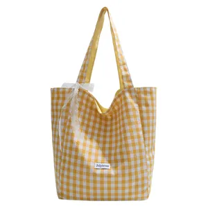 Minimalist yellow gingham canvas tote bag with a lace bow and white logo patch