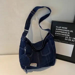 Dark blue denim crossbody tote bag with multi-pocket design and round coin purse