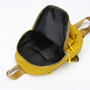 Unisex mustard yellow nylon crossbody bag with spacious interior and durable zip