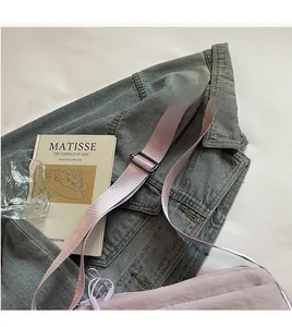 Detail of adjustable shoulder strap on light purple water-resistant nylon crossbody bag