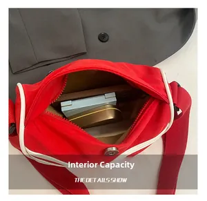 Macro shot of red canvas dumpling bag interior showing large capacity for essentials