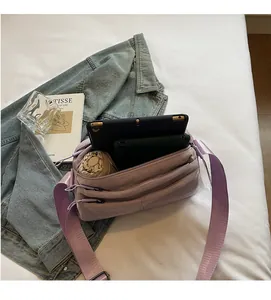 Detailed interior of purple crossbody bag with compartments for tablet and umbrella