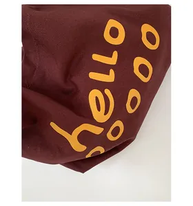Close-up of hello boo print on burgundy canvas tote bag showing high-quality fabric texture