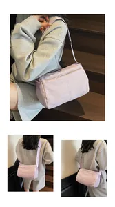 Detail of lavender nylon shoulder bag with adjustable strap and brand embroidery