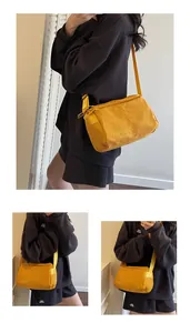 Detail of waterproof nylon shoulder bag with AMSSRA embroidery and adjustable strap