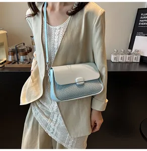 Detail showing woven texture on light blue crossbody bag with metal buckle closure