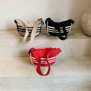 Canvas crescent moon crossbody bag with sporty stripes in cream, black and red