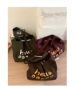 Three canvas tote bags in green, burgundy and brown with metallic magnetic buckle closures
