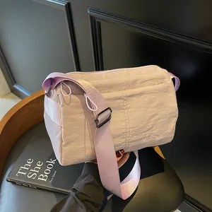 Light purple waterproof nylon crossbody bag with wide strap and logo embroidery